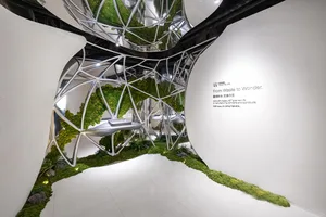 A modern, minimalist space filled with lush greenery and a dome-shaped structure, with soft and diffused lighting creating a warm ambiance