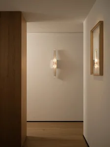 Bright and inviting hallway with a white wall, a wooden door, and warm lighting