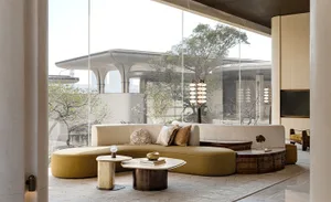 A well-lit living room with a large couch, coffee table, and various decorative items, creating a cozy and inviting atmosphere