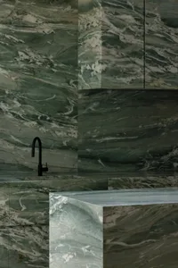 浴室有白大理石 countertop、水槽以及昏暗的照明，創造出溫馨的氛圍