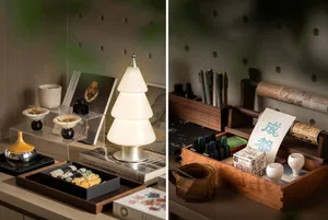 A cozy living space with a desk and various furniture pieces, featuring a warm atmosphere and a mix of textures and colors
