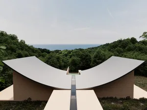 A modern building with a curved wood roof, surrounded by a forest, with natural light and a serene atmosphere