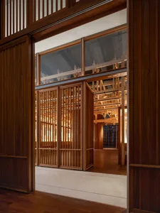 A dimly lit room with wooden walls and floor, creating a warm and intimate atmosphere