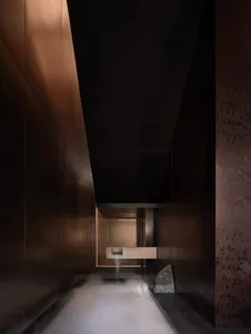 Modern bathroom with a shower in the corner and a sink nearby, well-lit and easy to clean