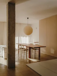 A warm and inviting dining area with a wooden table and chairs, surrounded by natural light from the windows