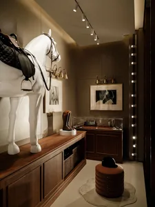 A room with a horse statue, wooden floor, and decorative items such as a chair, clock, and vase, creating an elegant atmosphere