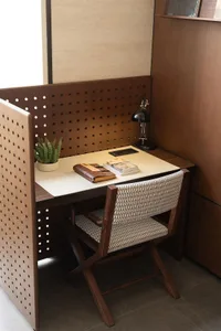 A study with a wooden desk, chair, and books, creating a warm and inviting atmosphere for reading and studying