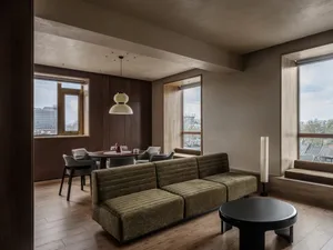 Comfortable living space with a couch in the center, a dining table on the left, and a lamp on the right, well-lit and inviting