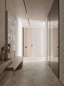 A well-lit modern hallway with a white color scheme, wood accents, and comfortable seating area with a bench