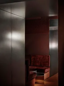 Cozy living room with a brown couch and chair, dim lighting, and a warm atmosphere