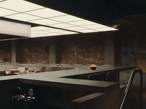 Cozy kitchen with a stone countertop, sink, and dim lighting