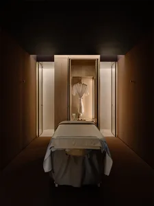 Cozy bedroom with a bed, chair, and closet, featuring a wooden floor and inviting atmosphere