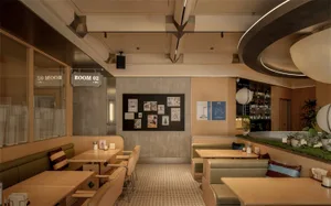 A dimly lit restaurant with a modern design, featuring a combination of wood and metal elements, tables, and chairs