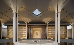 A modern lobby with a circular pool, white surfaces, and natural light from windows, featuring comfortable seating and a clean design