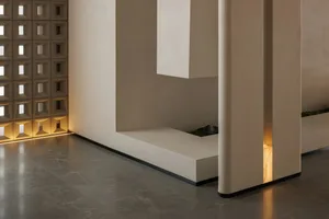Cozy living space with a white bench, dim lighting, and modern design