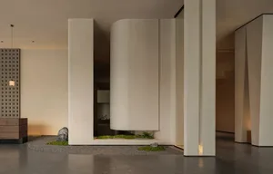 Modern building with a white exterior, curved wall, and natural light streaming through the windows