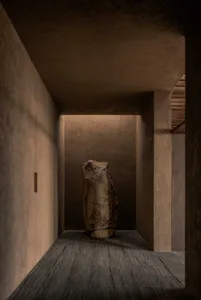 A stone sculpture on a wooden stand in a dimly lit room with a mysterious atmosphere