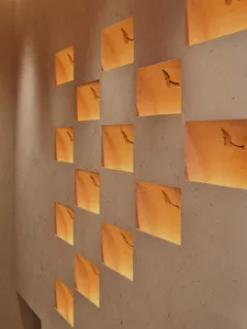 A cozy living space with a unique bird cutout wall design, soft lighting, and light-colored walls