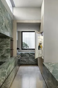 Well-lit kitchen with a white refrigerator, sink, and marble countertop, set against a bright and airy background