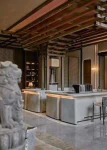 Well-lit modern kitchen with a marble countertop and sink, featuring a contemporary design with a focus on functionality and aesthetics
