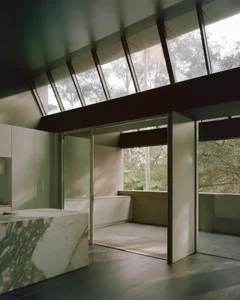 Bright and inviting bathroom with a marble countertop, sink, and natural light from a large window
