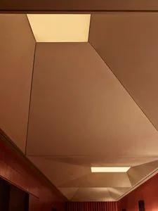 A bright and inviting room with a high ceiling, modern design, and a prominent ceiling light