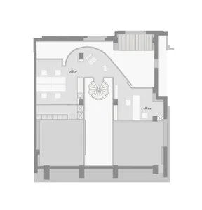 Black and white floor plan of a large room with a spiral staircase, furniture, and linework indicating room connections and measurements