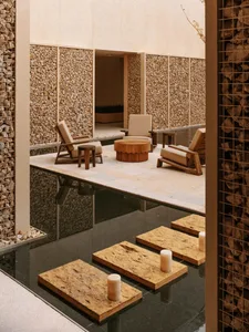 Cozy living space with stone floor, walls, and furniture, featuring a warm and inviting atmosphere