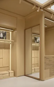 Wooden dressing room with a large mirror, a bench, and a chair, creating a warm and cozy atmosphere