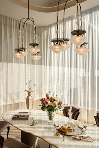 Cozy modern living space with a dining table, comfortable furnishings, and natural light from a large window