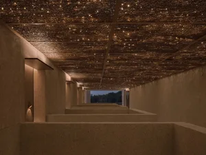 A dimly lit hallway with brown and tan walls, lined with rooms and doorways, creating a cozy and inviting atmosphere