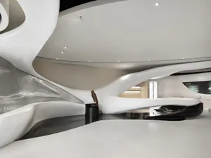 A modern, white, and curved building with a large, open interior and a clean and minimalist design