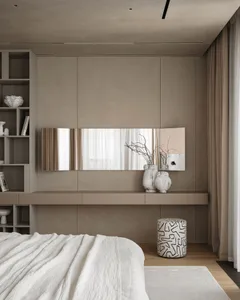 A calm and serene bedroom with a white bed and mirror, featuring a clean and minimalist design with a focus on functionality and simplicity