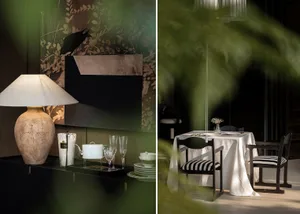 Black and white dining room with a table, chairs, vase, and lamp, featuring an elegant and sophisticated atmosphere