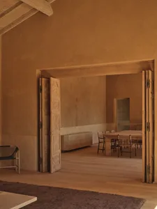 Dining area with a wooden floor, a dining table, and natural light from a doorway