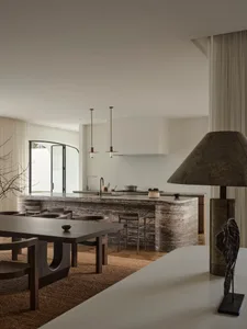 Modern kitchen with a marble countertop, center island, dining table, and well-lit space
