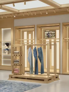 A store display featuring blue jeans on a wooden rack, arranged in various positions, with focused lighting highlighting the jeans