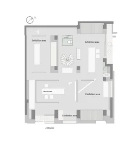 White and black floor plan of a modern building with multiple rooms and a central lobby or exhibition space, featuring clean lines and a focus on functionality