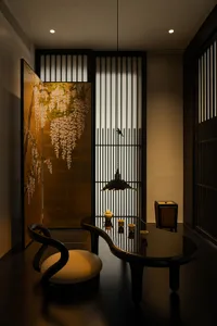 Cozy dining space with a wooden table and chairs, dimly lit with a doorway in the background