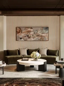 A modern living room with a green sofa, coffee table, chair, and vase, well-lit and inviting