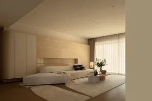 Cozy bedroom with a wooden floor, a bed, a table, and a vase, decorated in a white color scheme