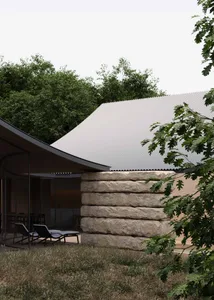 A modern house with a stone facade and a patio area featuring a dining table and chairs, set in a relaxed and inviting outdoor space
