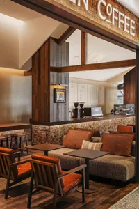 A warm and inviting restaurant interior with a combination of seating options, soft lighting, and decorative elements
