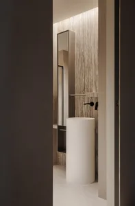 A well-lit bathroom with a white toilet, sink, and mirror, creating a clean and modern atmosphere