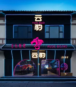 A black building with a neon sign in a foreign language, creating a lively and inviting atmosphere