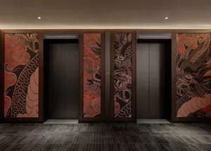A dimly lit hallway with two unique doors featuring Asian-inspired artwork, set against a warm wooden backdrop