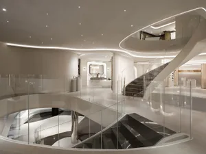 Large modern building with a glass spiral staircase, high ceiling, and open space, featuring clean lines and minimalistic design