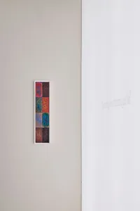 A colorful abstract painting on a white wall, with vibrant colors and lively lighting