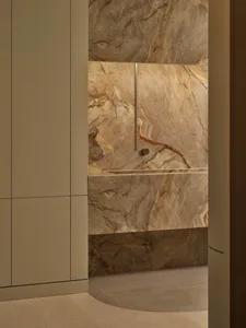 Bathroom with a marble countertop, modern fixtures, and dim lighting creating a moody atmosphere