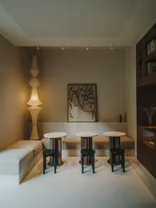 Cozy living room with black furniture, dim lighting, and a clean minimalist design